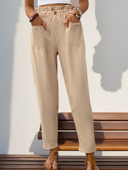 Tan linen blend trousers with gathered waist, button detail, and cuffed hem.