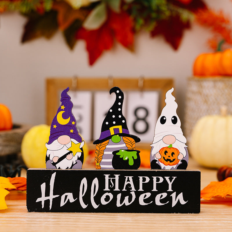 Halloween gnome trio display with purple, black, and white gnomes holding a star, cauldron, and pumpkin.