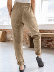 Camel corduroy tapered trousers with drawstring waist and cuffed hems.