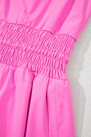 Fuchsia pink active romper set with smocked waist detail and side seams.