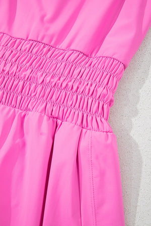 Fuchsia pink active romper set with smocked waist detail and side seams.