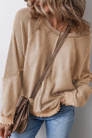 Tan waffle knit raglan sweatshirt with contrast fabric and raw edge details.