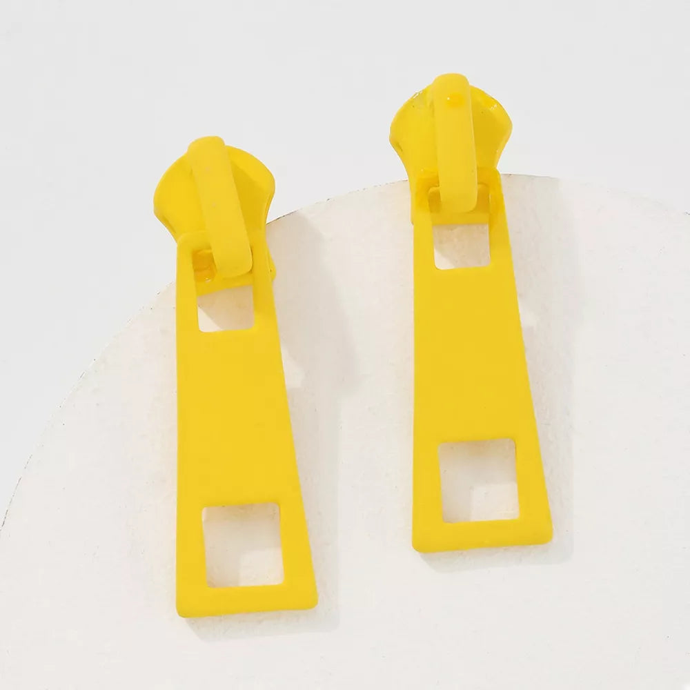 Yellow zipper drop earrings with square cutouts and alloy material.