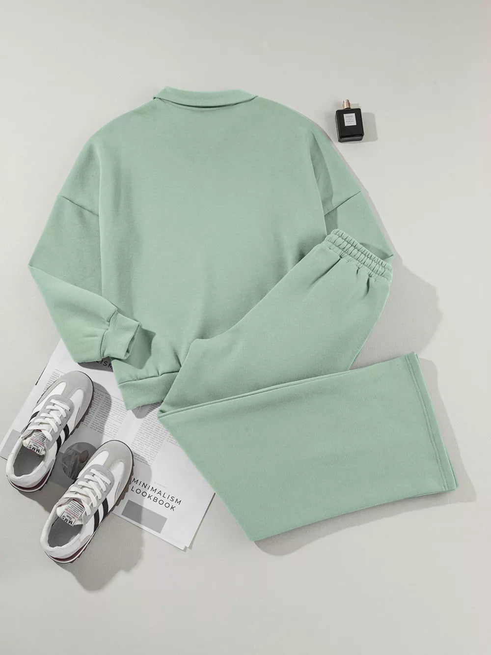 Sage cotton zip-up jacket and drawstring pants set with collared neckline and elastic cuffs.