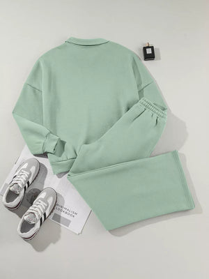 Sage cotton zip-up jacket and drawstring pants set with collared neckline and elastic cuffs.
