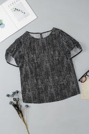 Black dotted puff sleeve blouse with a round neckline.