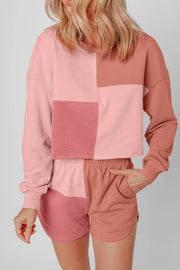 Colorblock lounge set with cropped sweatshirt and shorts in pink and dusty rose hues.