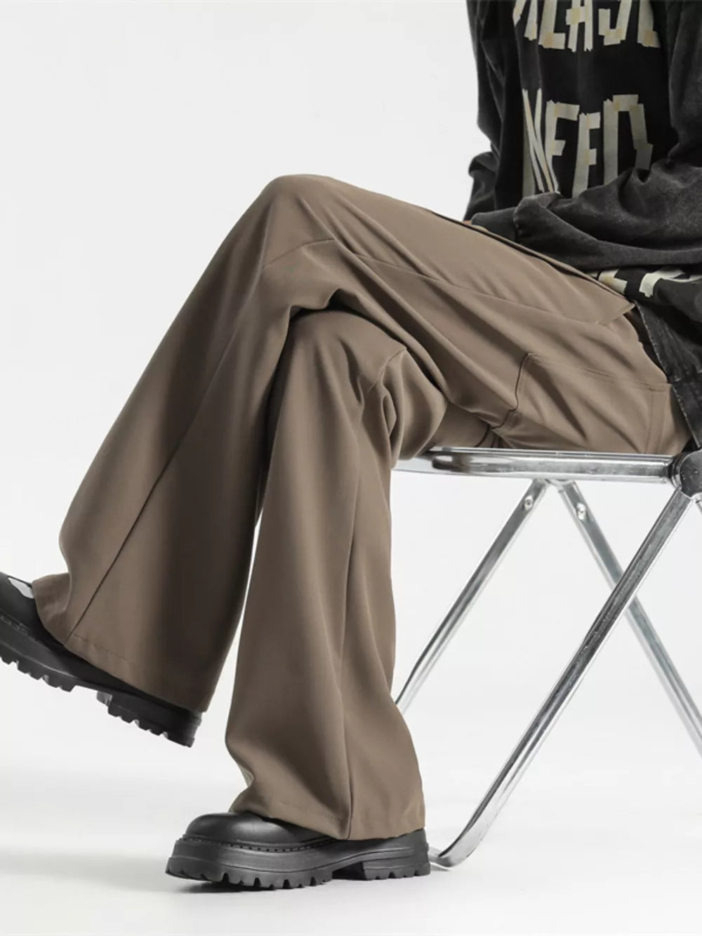 Relaxed fit wide-leg men's sweatpants in coffee color, styled casually.