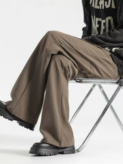 Relaxed fit wide-leg men's sweatpants in coffee color, styled casually.