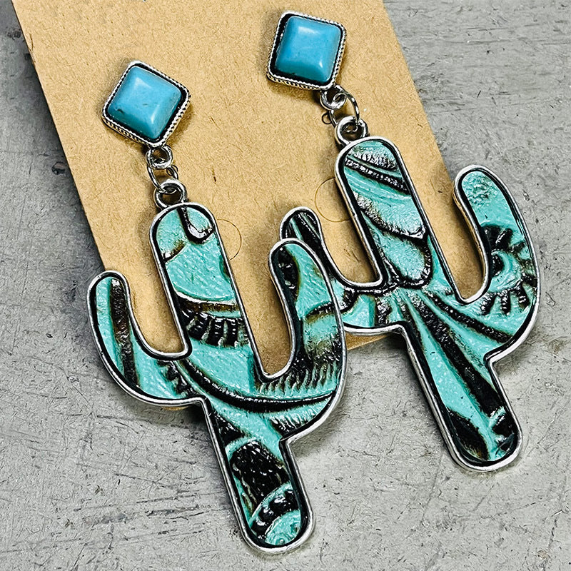 Turquoise cactus silhouette drop earrings with embossed detail and silver-tone alloy.
