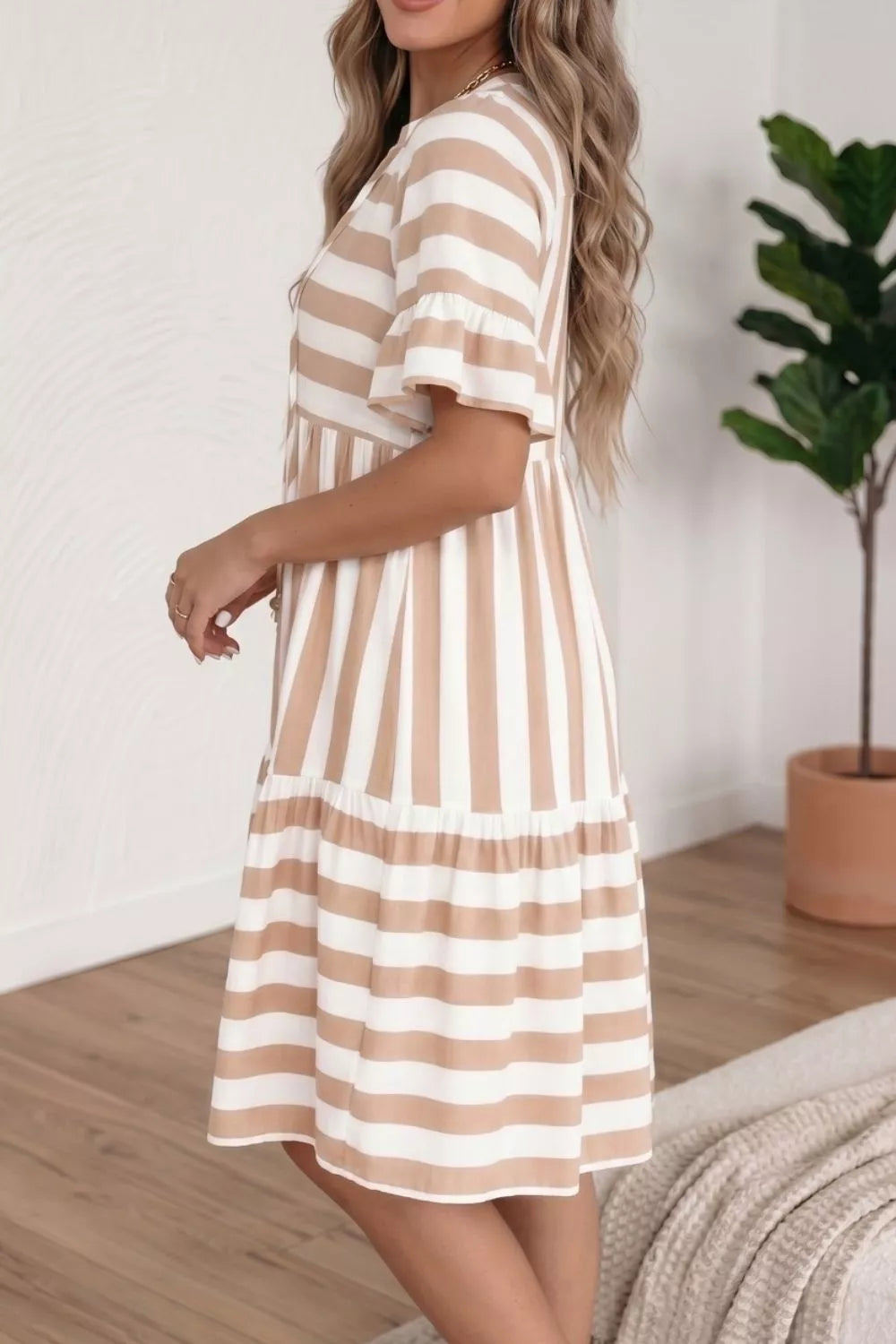 Chic striped v-neck flared summer dress with button detail and ruffled sleeves.
