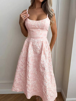 Blush pink textured floral a-line midi gown with spaghetti straps and a fitted bodice.