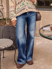 Light blue denim jeans with a high waist and flared leg, detailed with white stitching.
