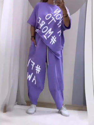 Purple graphic tee and drawstring pants set with white text detail.