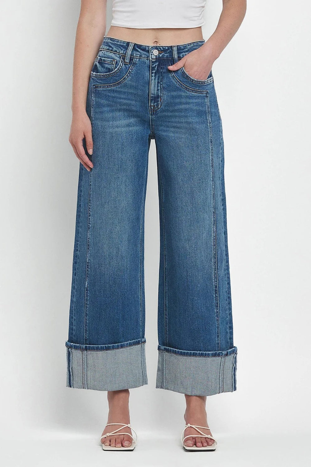 Wide-leg denim jeans in medium wash with large contrast cuffs.