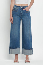 Wide-leg denim jeans in medium wash with large contrast cuffs.