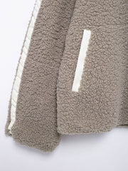 Dust Storm teddy fleece zip-up jacket with white contrast piping and pocket detail.