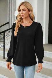 Black smocked cuff puff sleeve blouse with crew neck.