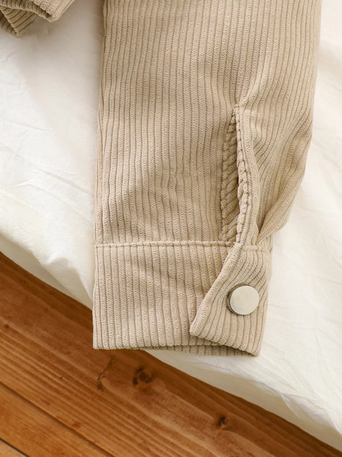 Casual tan corduroy jacket sleeve detail with button cuff and pocket