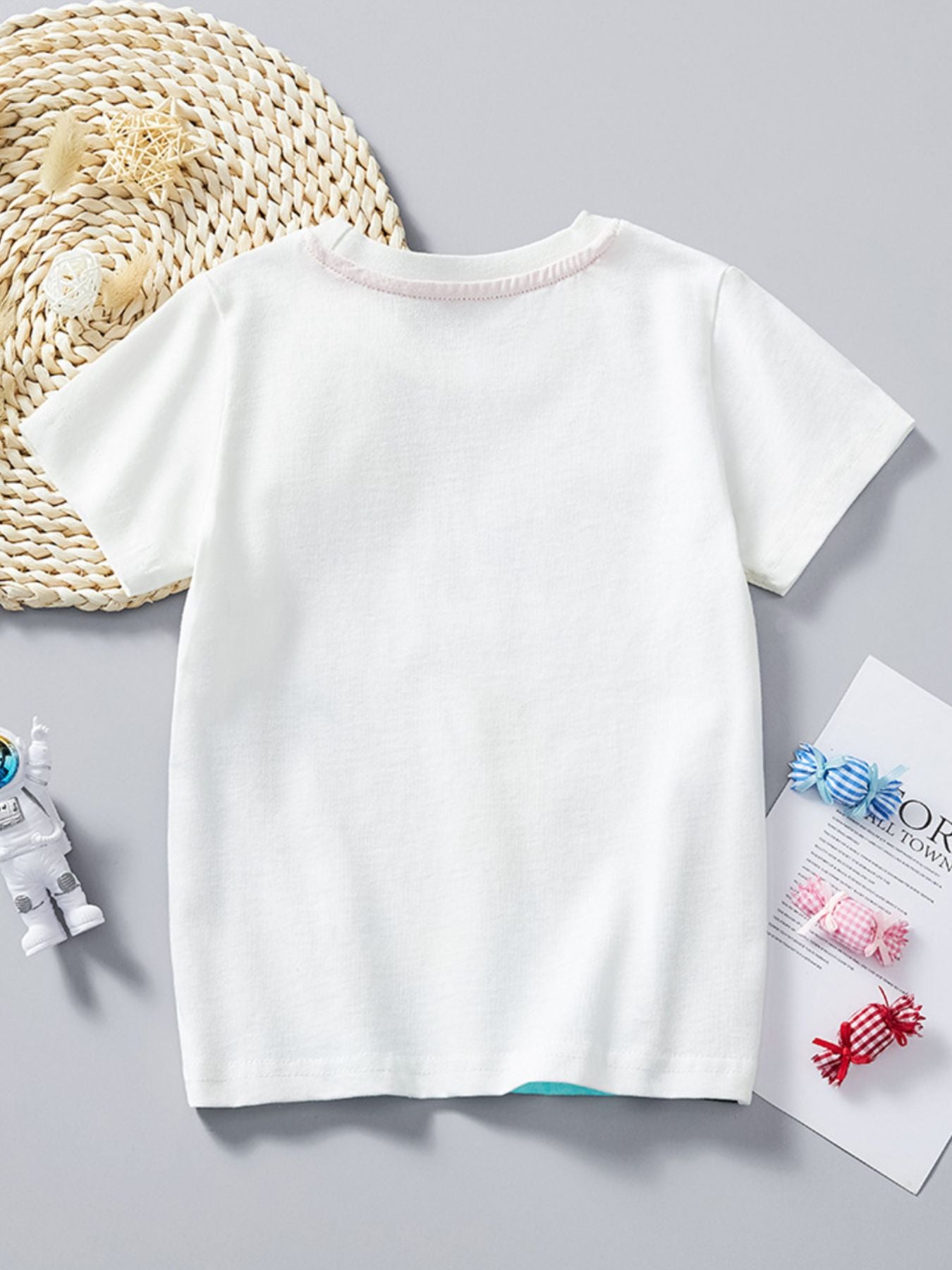 White cotton crew neck t-shirt with pink stitching detail at neckline.
