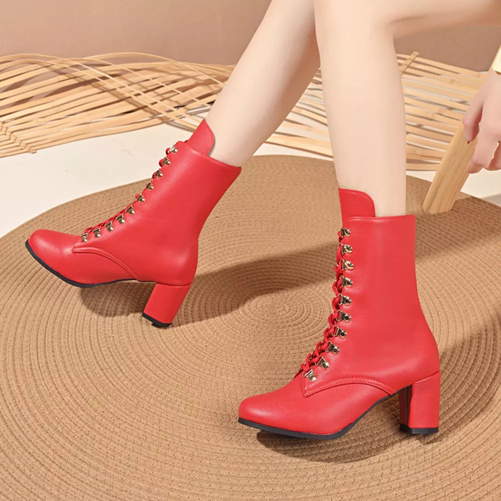 Red lace-up block heel boots with gold eyelets and a pointed toe.