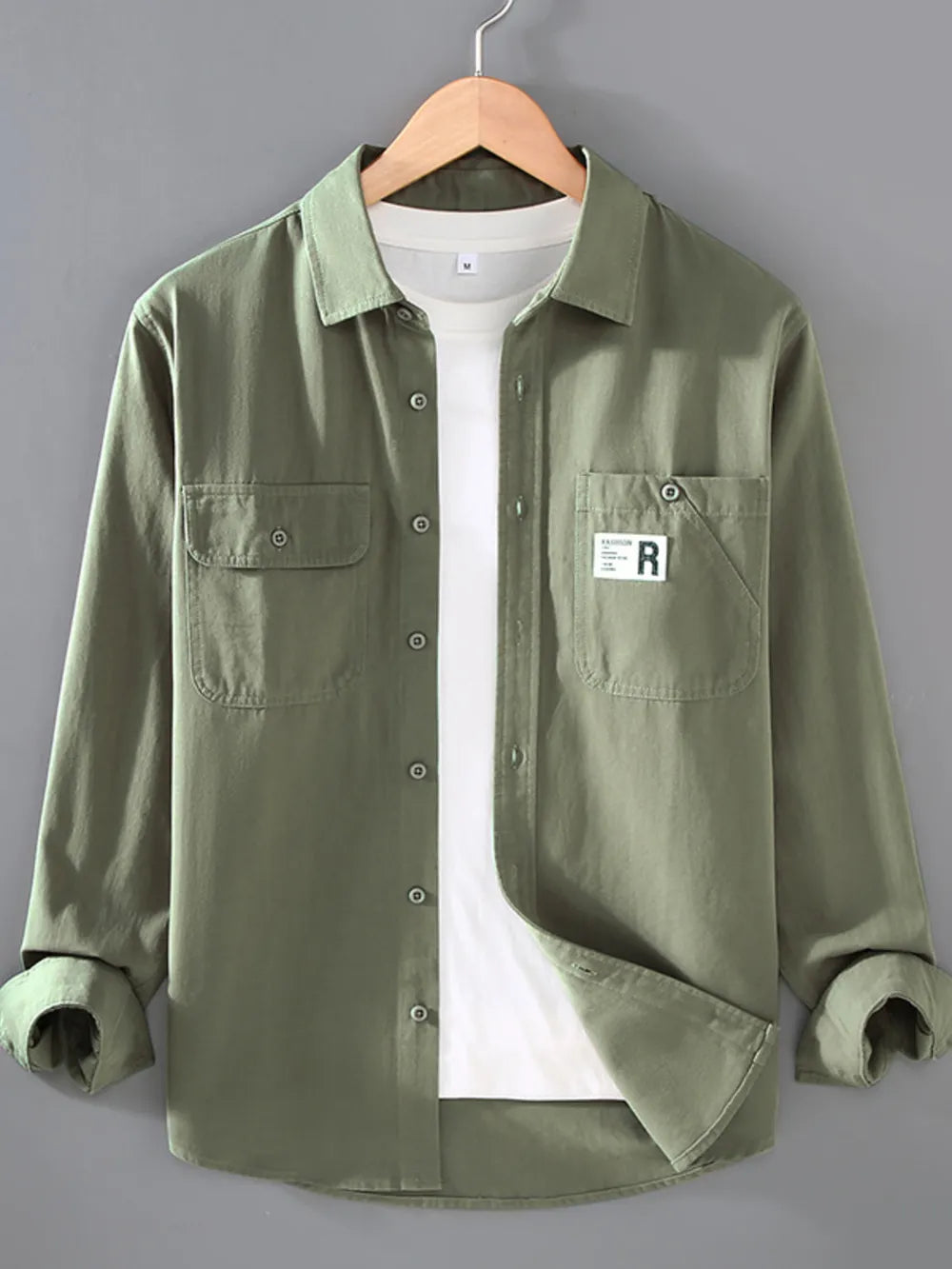 Men's gray green cotton long-sleeve overshirt with two chest pockets and button closure.