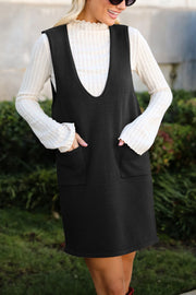 Black V-neck pocketed sweater dress with a ribbed mock neck top.