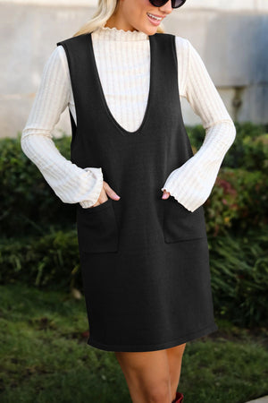 Black V-neck pocketed sweater dress with a ribbed mock neck top.