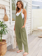 Relaxed pocketed overalls jumpsuit in sage green with V-neck and wide legs.