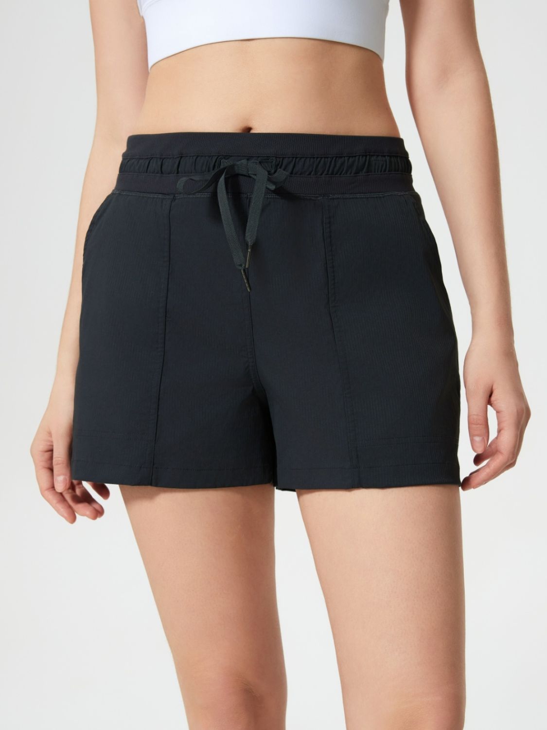 Black utility shorts with drawstring waist and textured fabric detail.