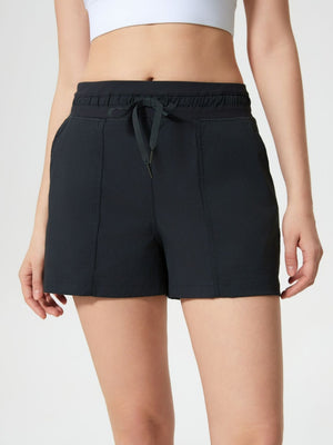 Black utility shorts with drawstring waist and textured fabric detail.