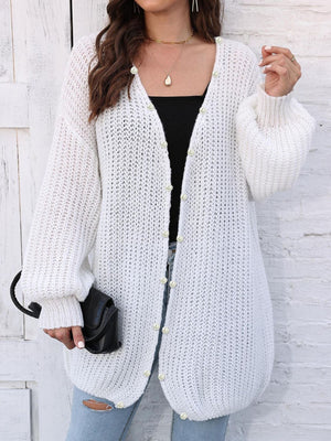 White balloon sleeve cardigan with pearl buttons and open front.