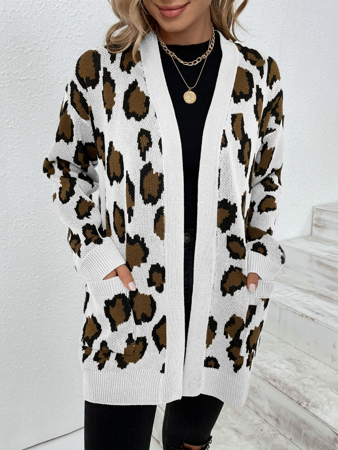 Leopard print open-front knit cardigan with white trim and pockets.