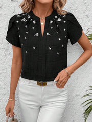 Black embroidered floral keyhole blouse with short sleeves and a split neckline.