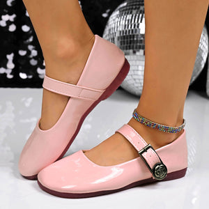 Pink patent buckle strap Mary Jane loafers with a rose detail on the buckle.
