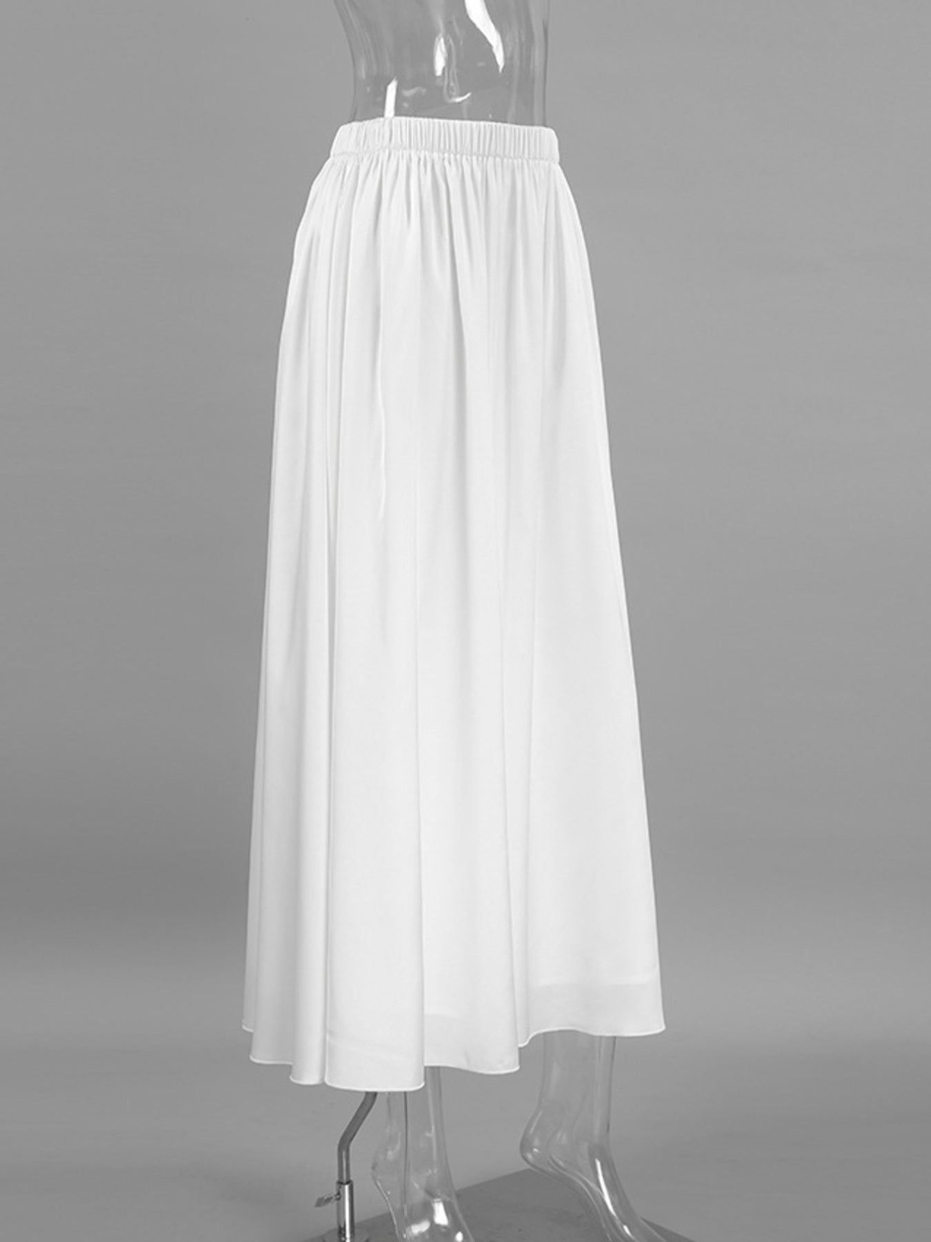 White high-waisted maxi skirt with elastic waistband and flowy silhouette.