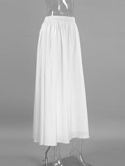 White high-waisted maxi skirt with elastic waistband and flowy silhouette.