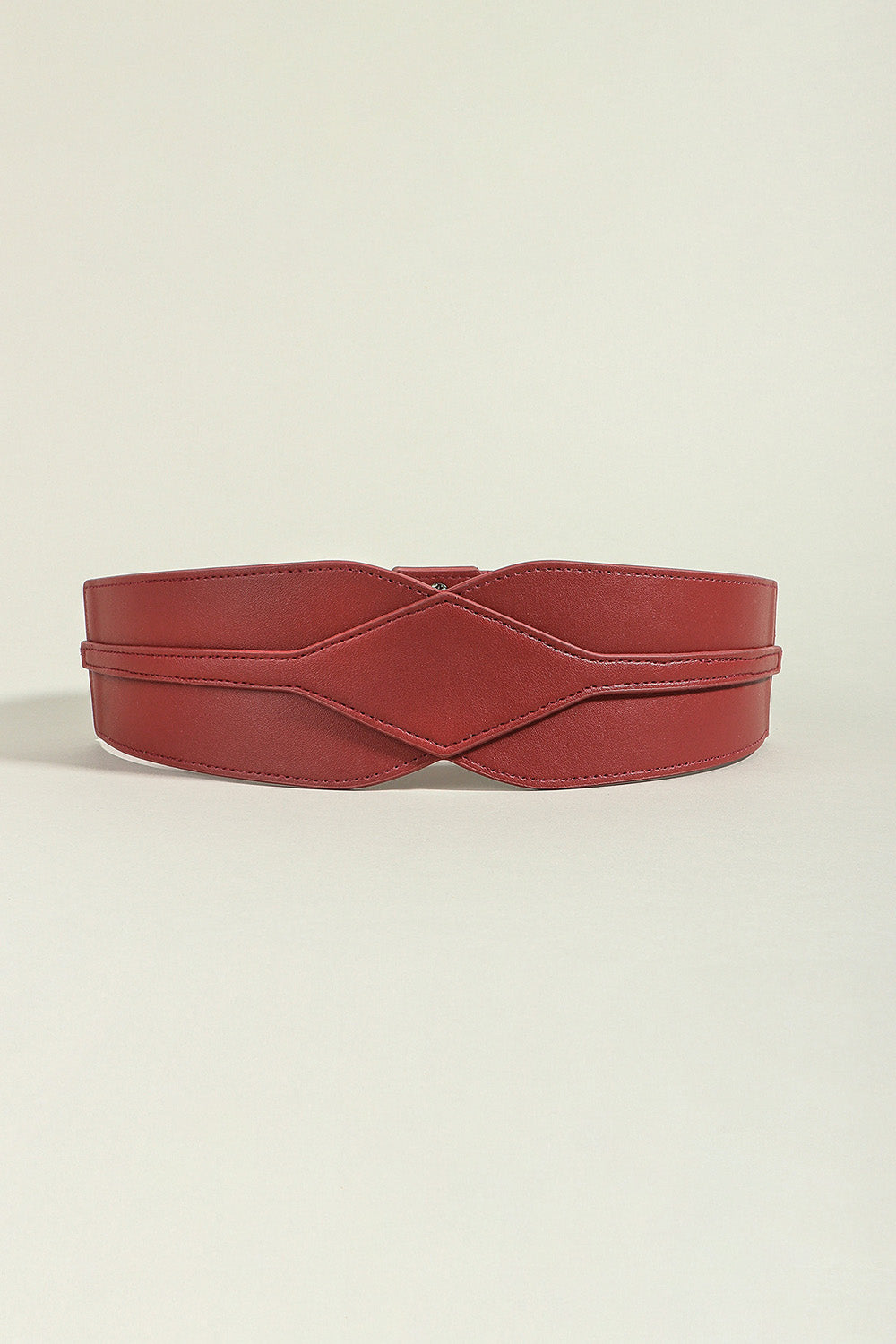 Burgundy elastic belt with sculpted waist detail and criss-cross design