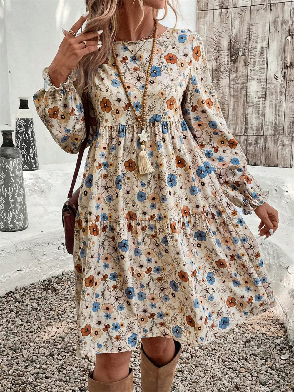 Floral tiered hem long sleeve dress with ruffled cuffs and a boho print.