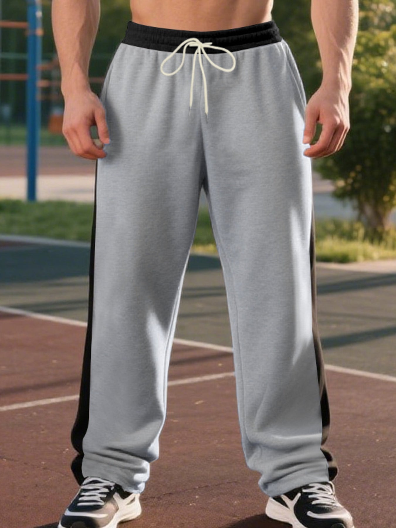 Men's light gray sweatpants with black side stripe and drawstring waist.