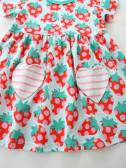 Toddler cotton dress with strawberry print and heart pockets.