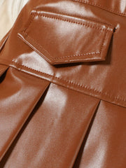 Brown faux leather toddler skirt with pleated detail and pocket.
