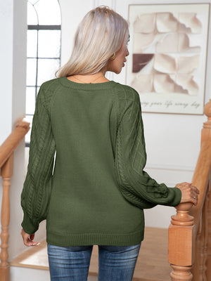 Cable knit henley sweater in matcha green with textured sleeves.