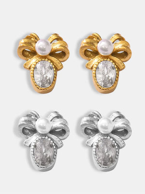 Gold and silver bow stud earrings with pearl and oval crystal details