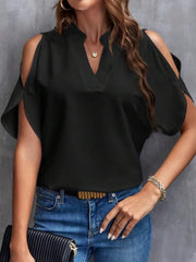 Black open-shoulder blouse with mandarin collar and v-neckline, styled with jeans.
