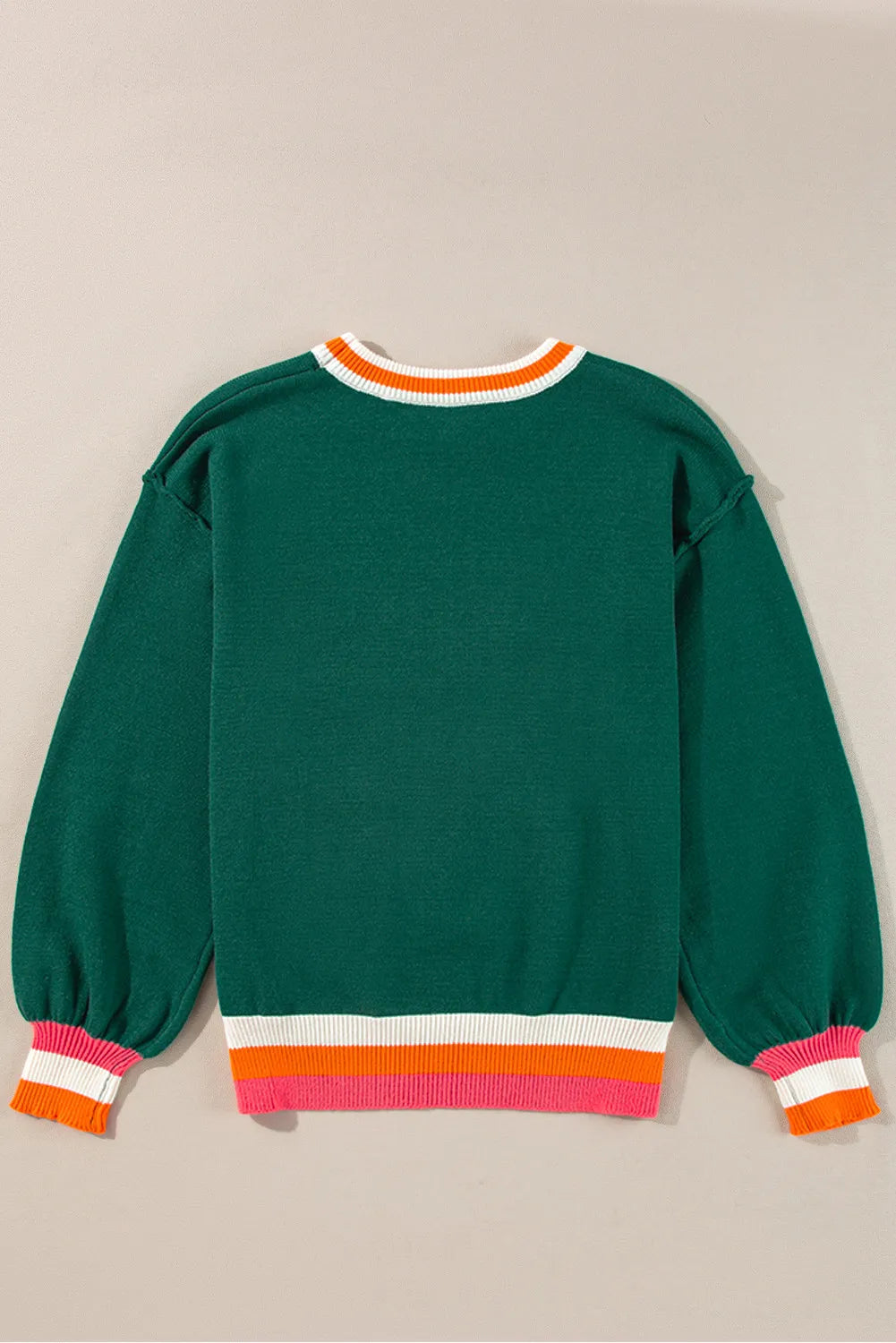 Dark green knit sweater with balloon sleeves and colorblock trim at neckline and hem.