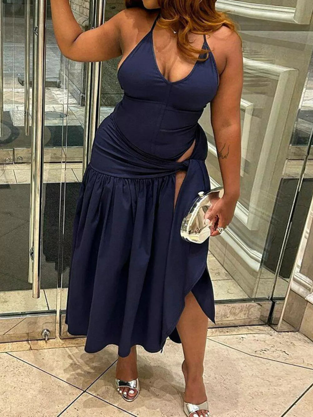 Navy blue halter neck ruched maxi dress with deep v-neck and thigh-high slit