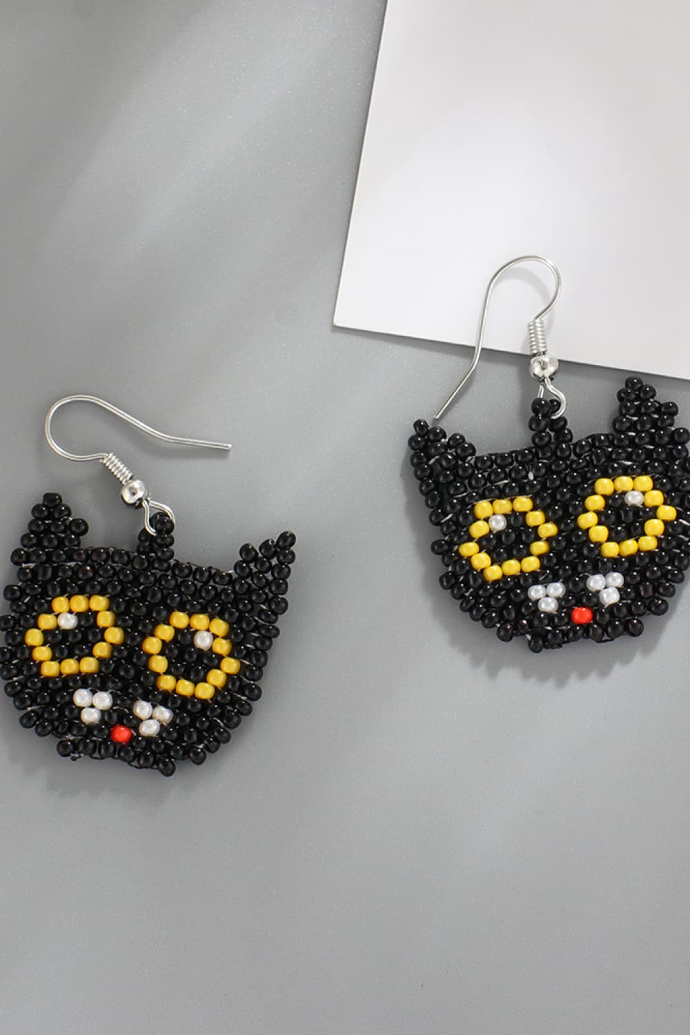 Black cat beaded earrings with yellow eyes and red nose.
