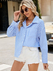Sky blue and white striped oversized shirt with button front and chest pockets.