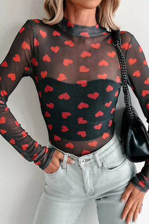 Black sheer mesh long sleeve top with all-over red heart print and mock neck.